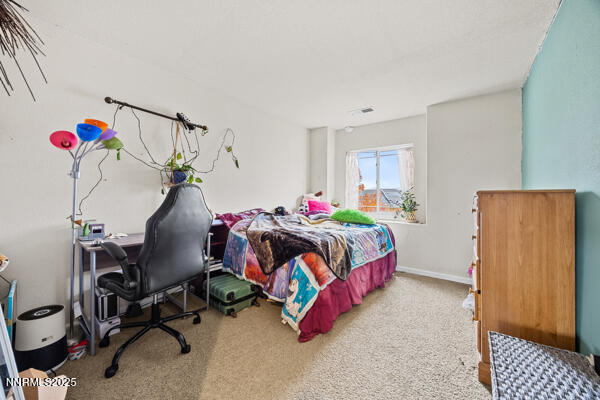 8994 Wynne Street Reno, NV 89506 - Photo 22 of 26 a bedroom with bed and a window