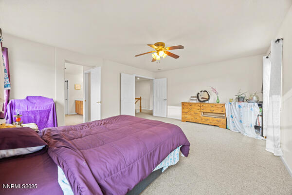 8994 Wynne Street Reno, NV 89506 - Photo 23 of 26 a bedroom with a bed and a couch
