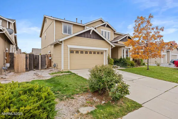 a view of a white house next to a yard with big trees