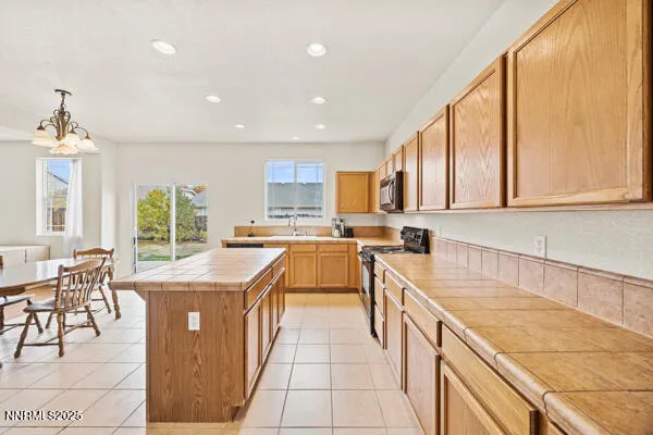 a kitchen with stainless steel appliances granite countertop a sink and a stove