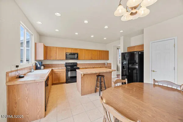 a kitchen with stainless steel appliances granite countertop a sink counter space cabinets and a stove