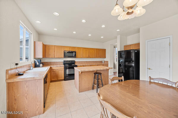 8994 Wynne Street Reno, NV 89506 - Photo 10 of 26 a kitchen with stainless steel appliances granite countertop a sink counter space cabinets and a stove