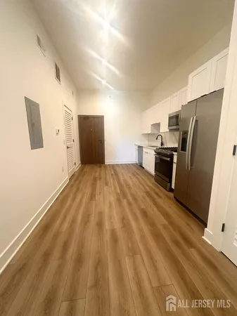 a view of a refrigerator in kitchen and a window