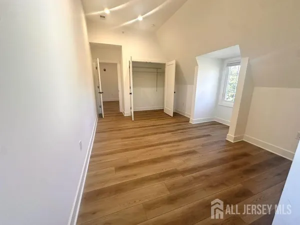 a view of a room with wooden floor and bathroom