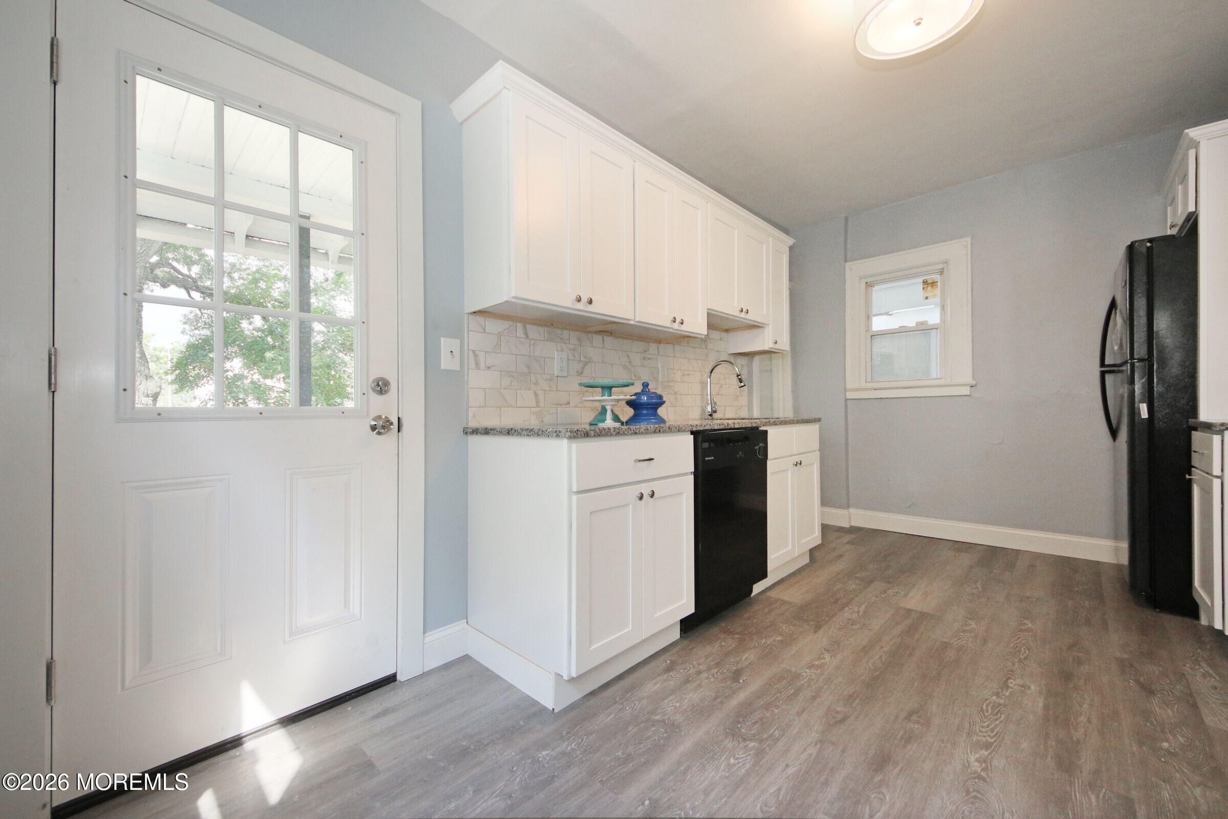 183 Ridge Avenue Asbury Park, NJ 07712 - Photo 14 of 23 a kitchen with a sink wooden floor and a window