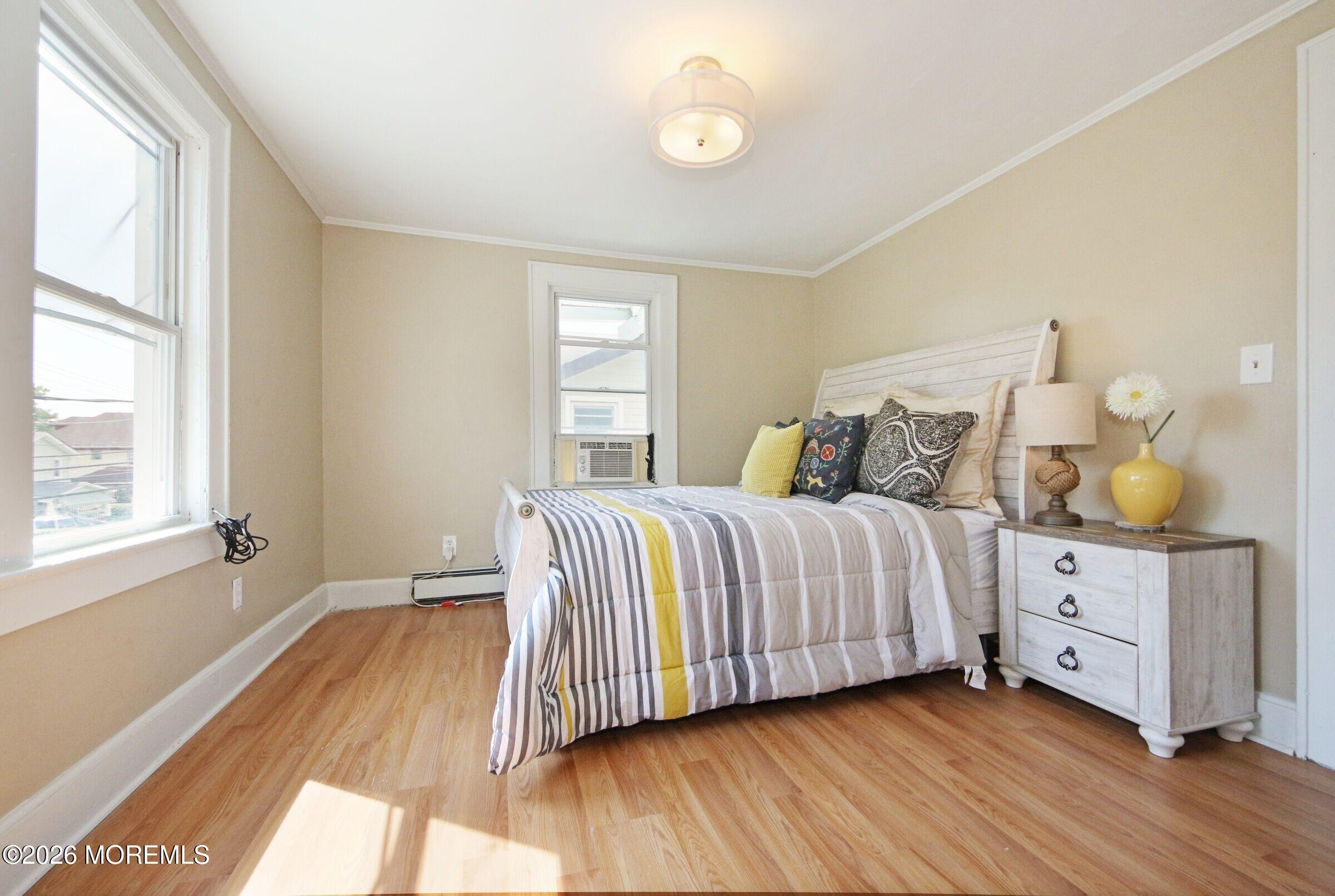 183 Ridge Avenue Asbury Park, NJ 07712 - Photo 17 of 23 a bedroom with a bed and window