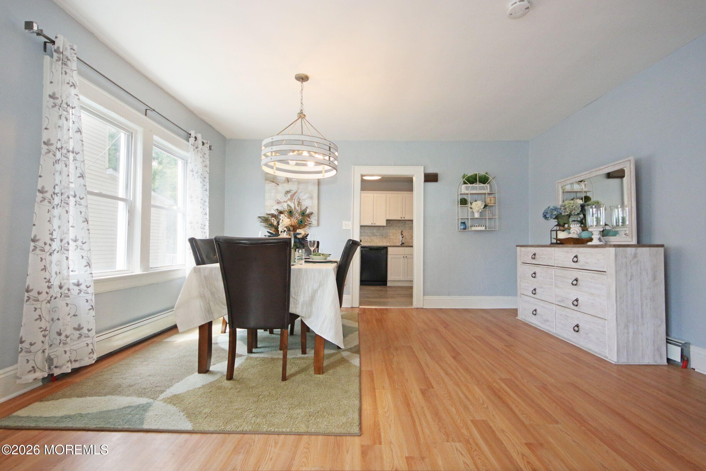 183 Ridge Avenue Asbury Park, NJ 07712 - Photo 9 of 23 a view of a dining room with furniture window and wooden floor