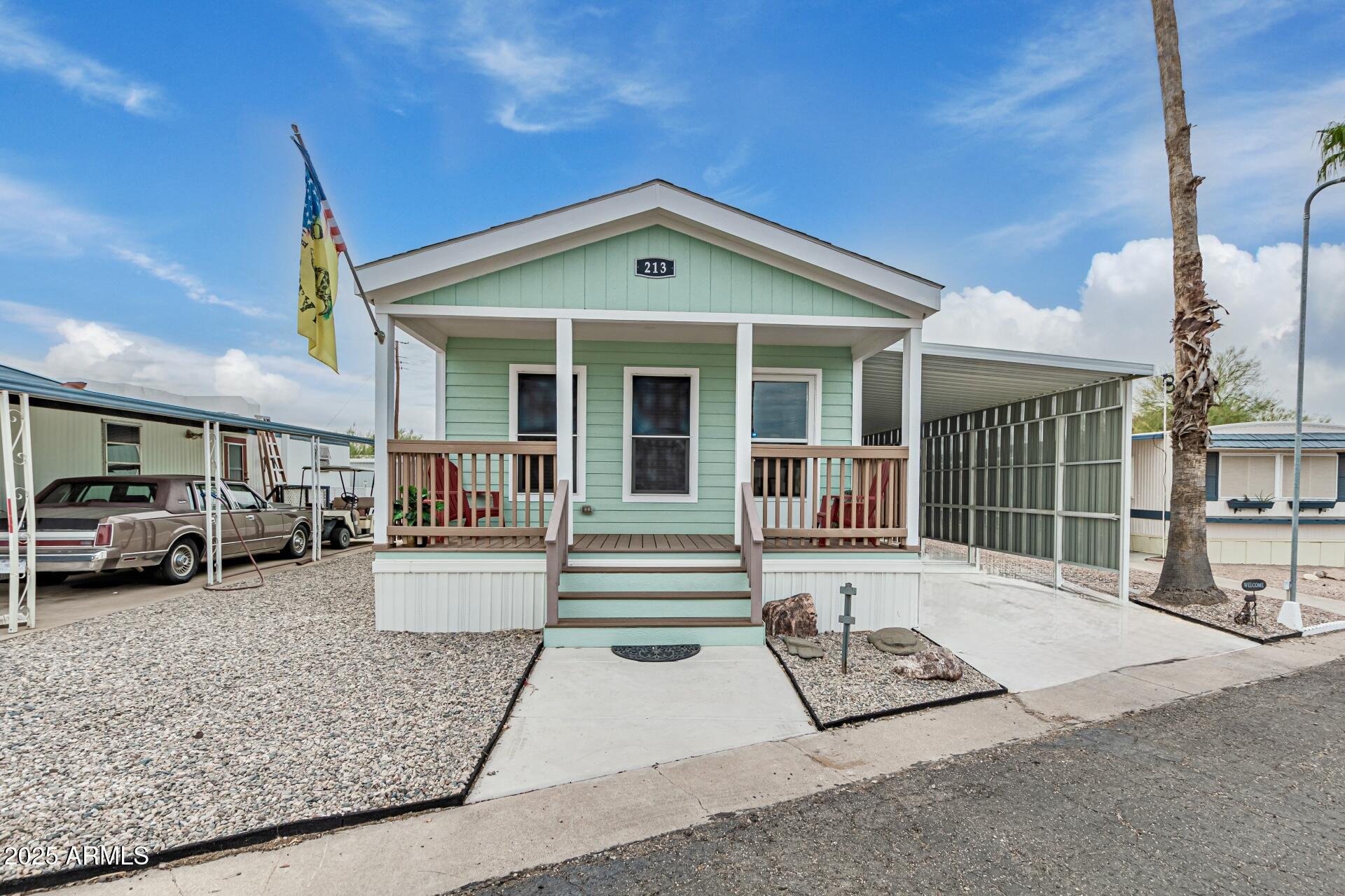 10220 East Apache Trail, Unit 213 Apache Junction, AZ 85120 - Photo 1 of 30 a view of a house with a patio and a yard