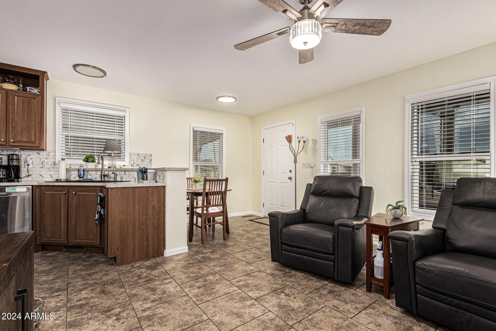 10220 East Apache Trail, Unit 213 Apache Junction, AZ 85120 - Photo 10 of 30 a living room with furniture a fireplace and a window