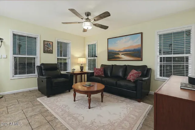 a living room with furniture a fireplace and a window