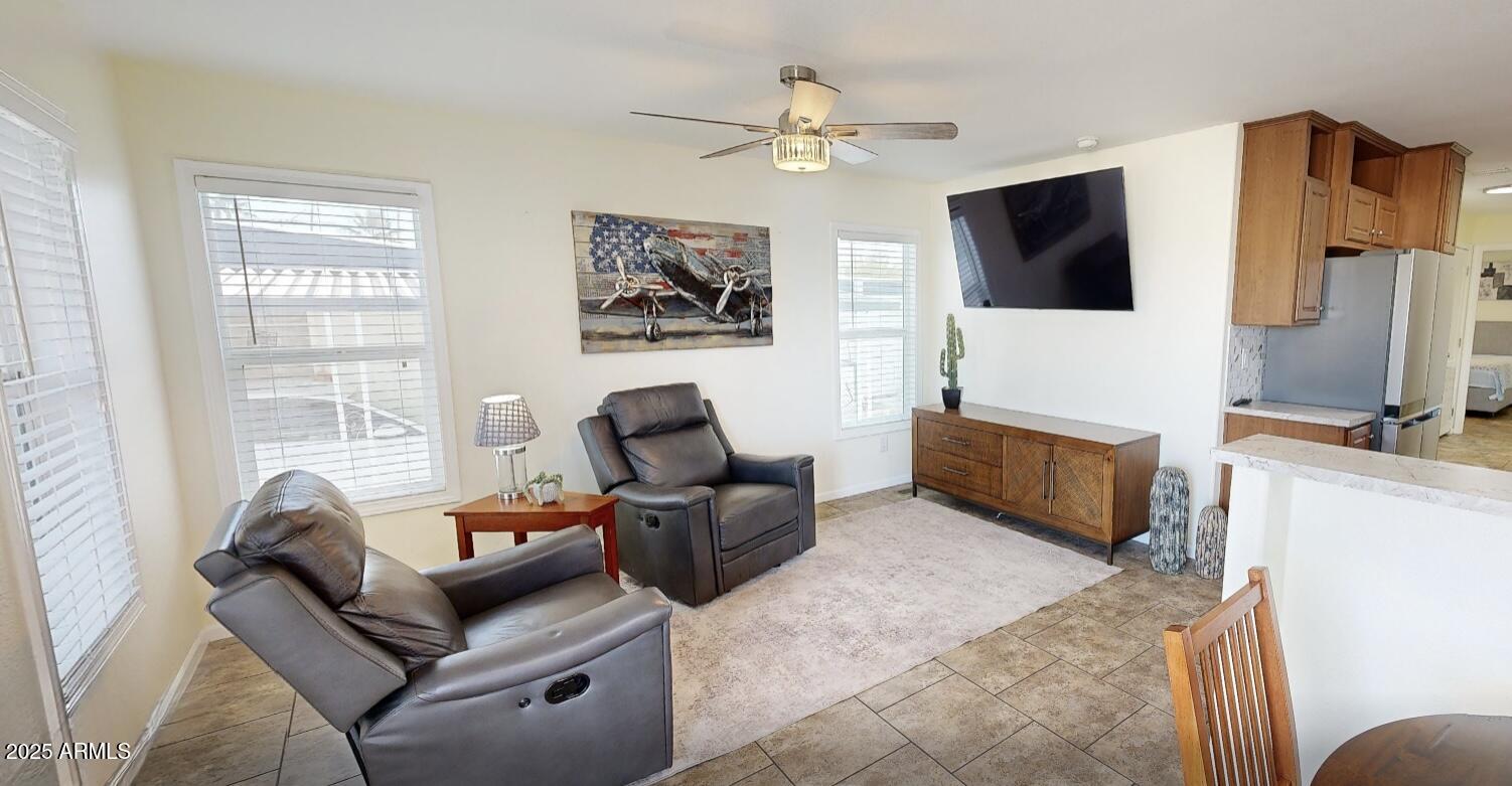 10220 East Apache Trail, Unit 213 Apache Junction, AZ 85120 - Photo 2 of 30 a living room with furniture and a flat screen tv