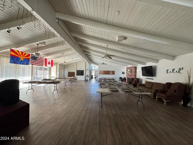 a room with lots of chairs and wooden floors