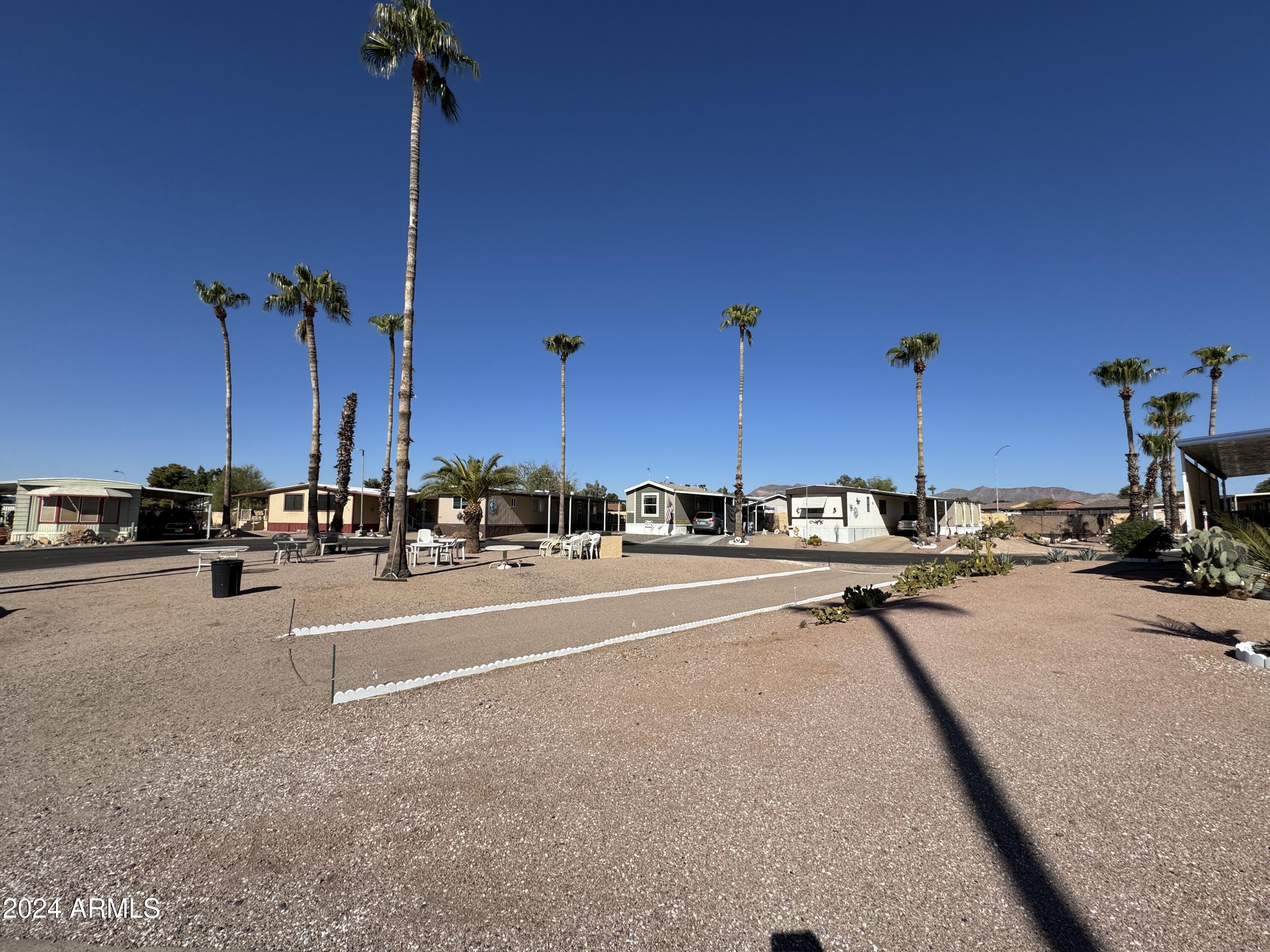 10220 East Apache Trail, Unit 213 Apache Junction, AZ 85120 - Photo 23 of 30 a view of a terrace with a table and chairs