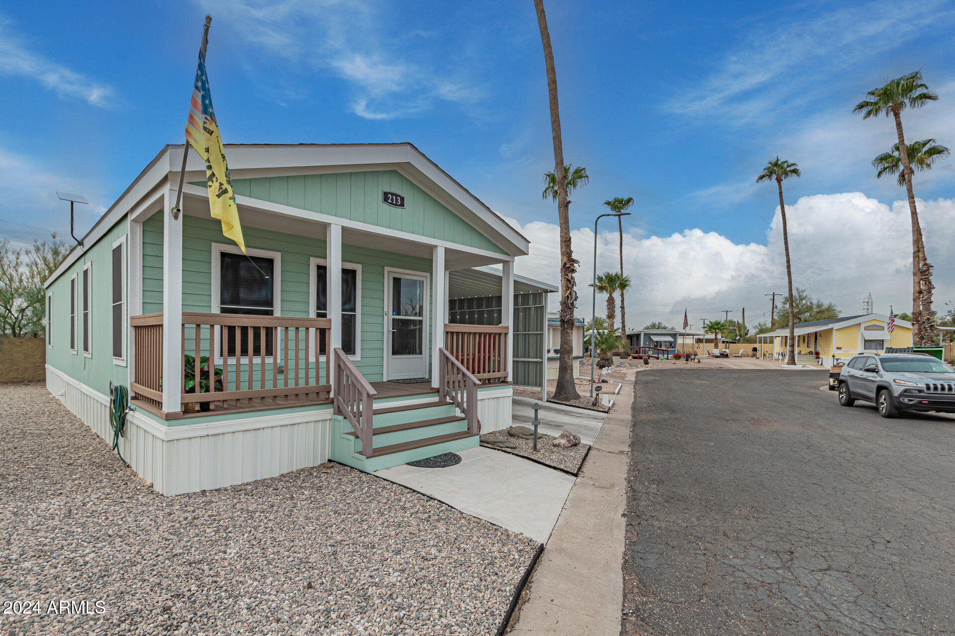 10220 East Apache Trail, Unit 213 Apache Junction, AZ 85120 - Photo 24 of 30 a view of a house with a porch and furniture
