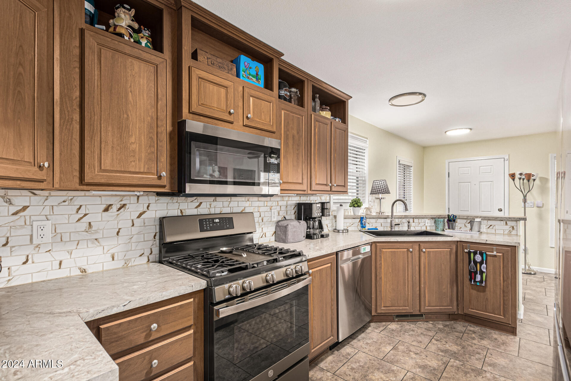 10220 East Apache Trail, Unit 213 Apache Junction, AZ 85120 - Photo 4 of 30 a kitchen with stainless steel appliances granite countertop a stove top oven a sink dishwasher and a microwave oven on the blue kitchen countertops