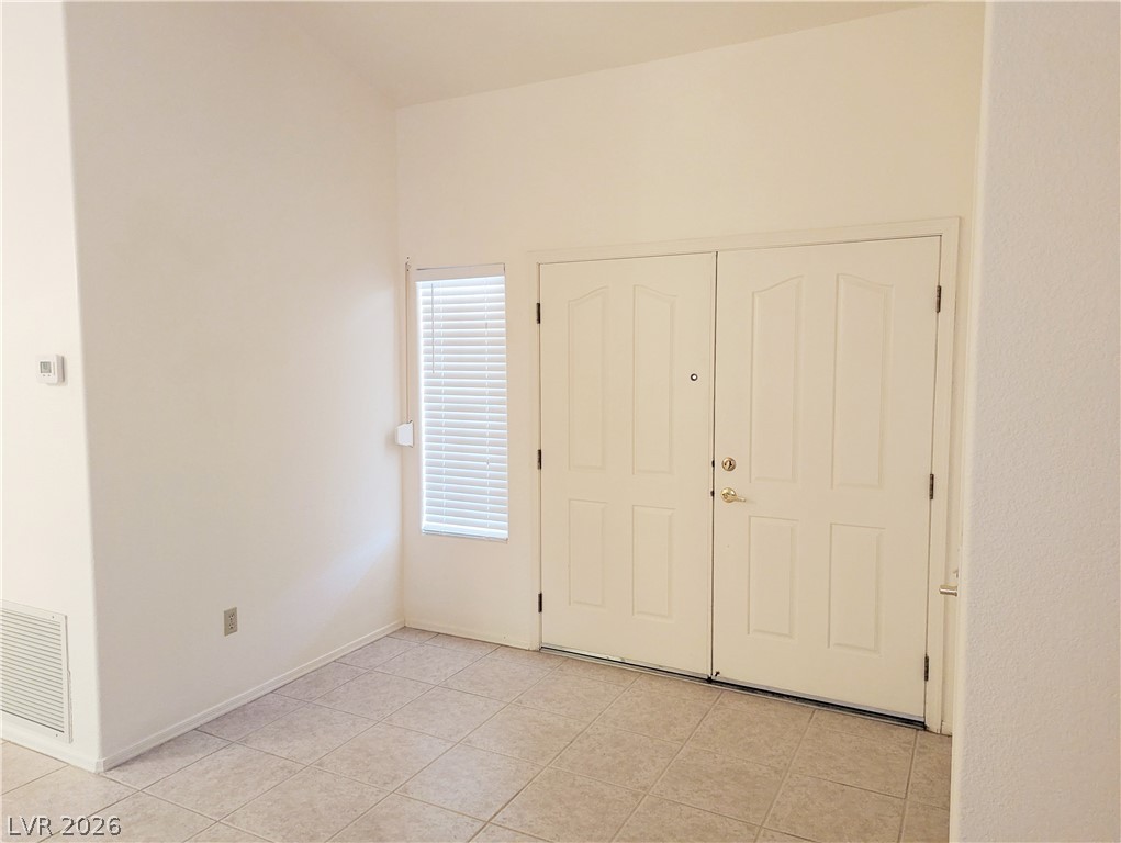 9433 Quail Ridge Drive Las Vegas, NV 89134 - Photo 2 of 23 A welcoming entryway with double doors and light-colored tile flooring.