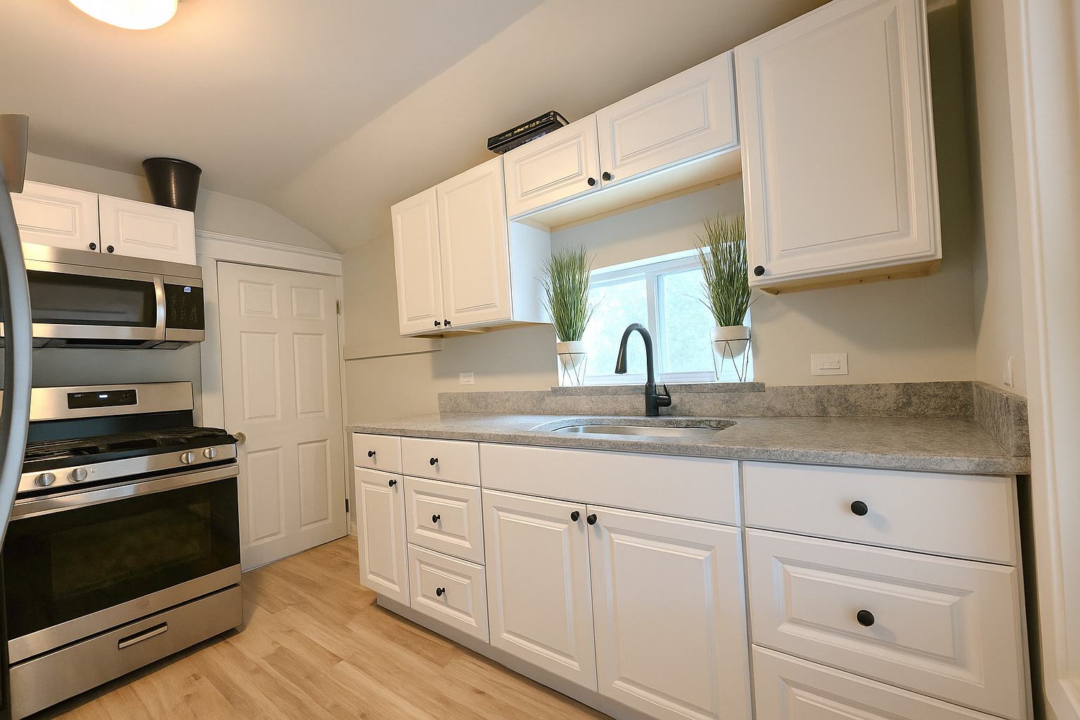 9 North Jackson Street Elgin, IL 60123 - Photo 5 of 13 a kitchen with granite countertop white cabinets and stainless steel appliances