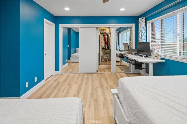 a bedroom with a bed and wooden floor