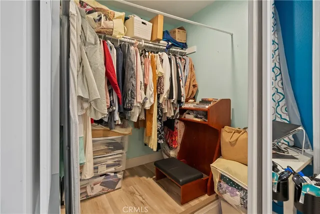 a view of walk in closet with clothes