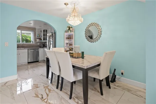 a view of a dining room with furniture and a chandelier