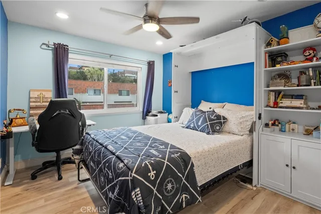 a bedroom with a bed dresser and a window