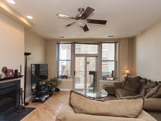 3113 West Lawrence Avenue, Unit D302 Chicago, IL 60625 - Photo 3 of 16 a living room with furniture fireplace and a large window