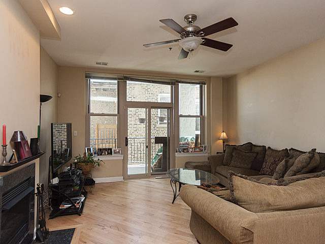 3113 West Lawrence Avenue, Unit D302 Chicago, IL 60625 - Photo 4 of 16 a living room with furniture and a large window