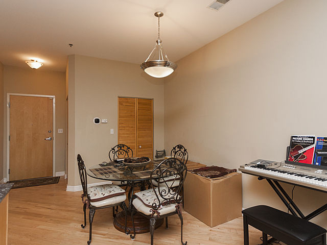 3113 West Lawrence Avenue, Unit D302 Chicago, IL 60625 - Photo 7 of 16 a dining room with furniture and window