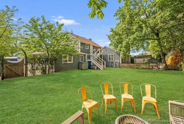 a view of a chair and table in the garden