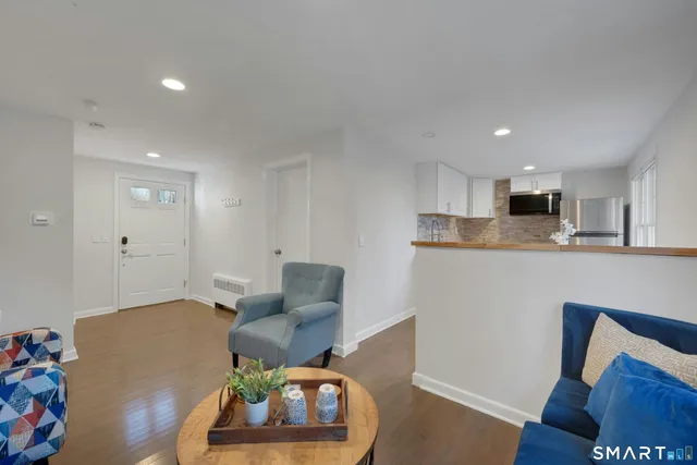a living room with furniture and kitchen view