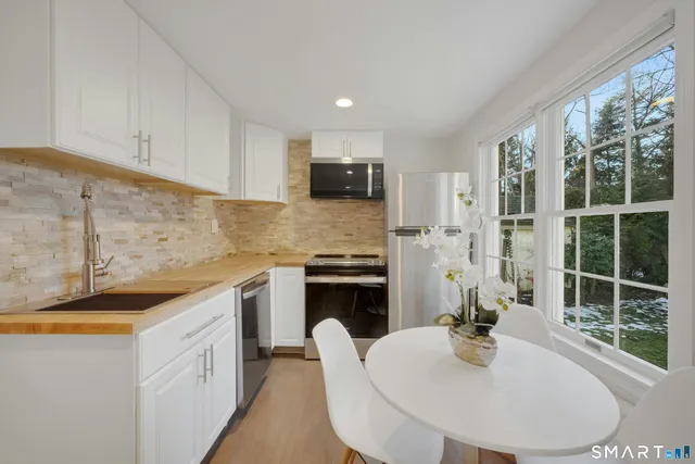 a kitchen with a sink stove and microwave