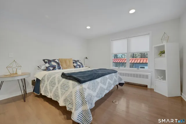 a bedroom with a bed and a window