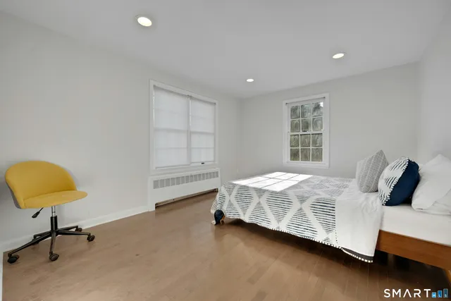 a bedroom with bed and window