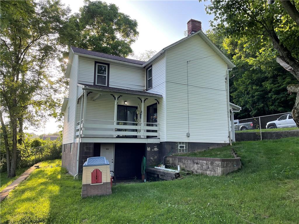 223 Lenkey Road Vanderbilt, PA 15486 - Photo 17 of 18 a front view of house with yard and trees in the background