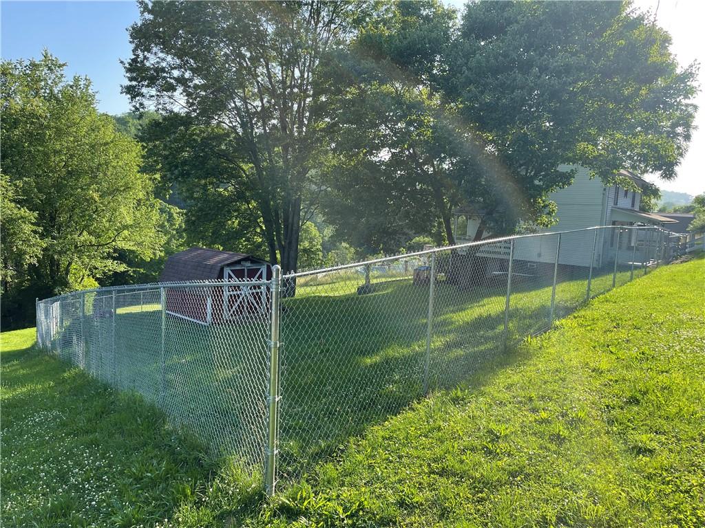 223 Lenkey Road Vanderbilt, PA 15486 - Photo 18 of 18 a backyard of a house with a yard and outdoor seating