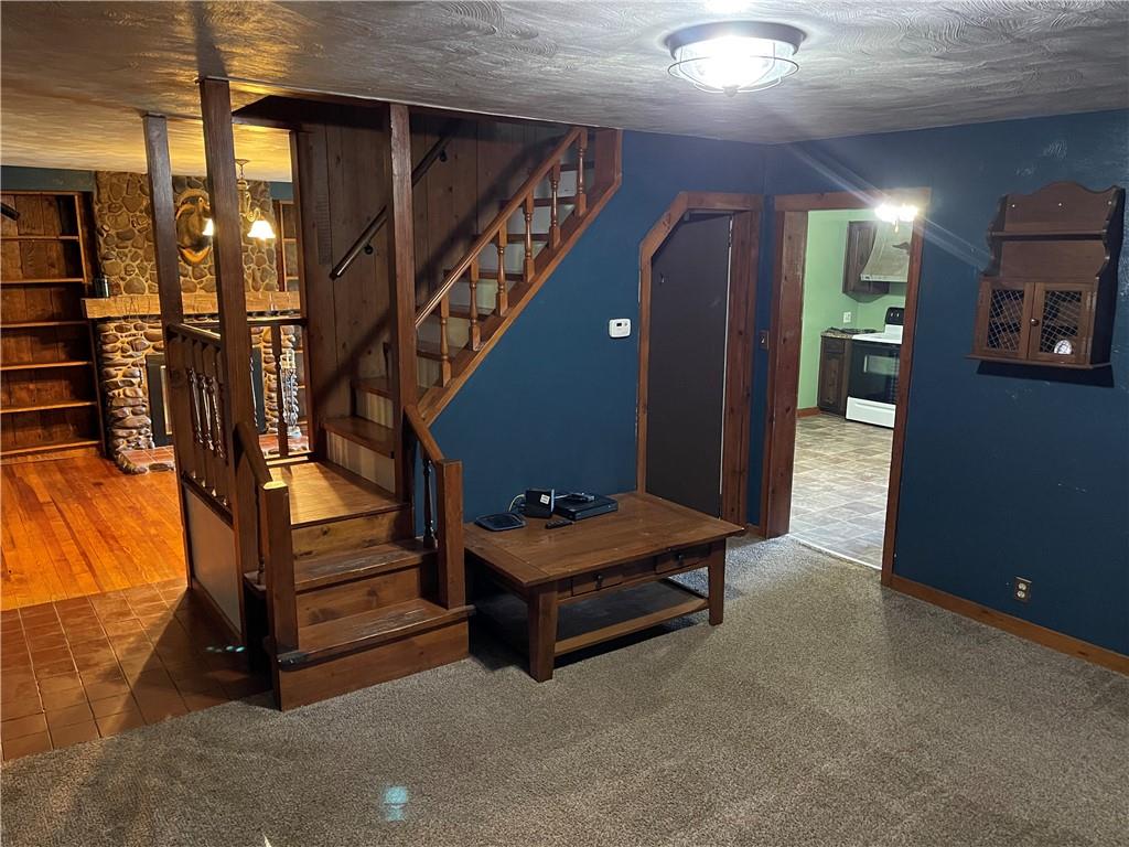 223 Lenkey Road Vanderbilt, PA 15486 - Photo 3 of 18 a room with stairs and a wooden floor
