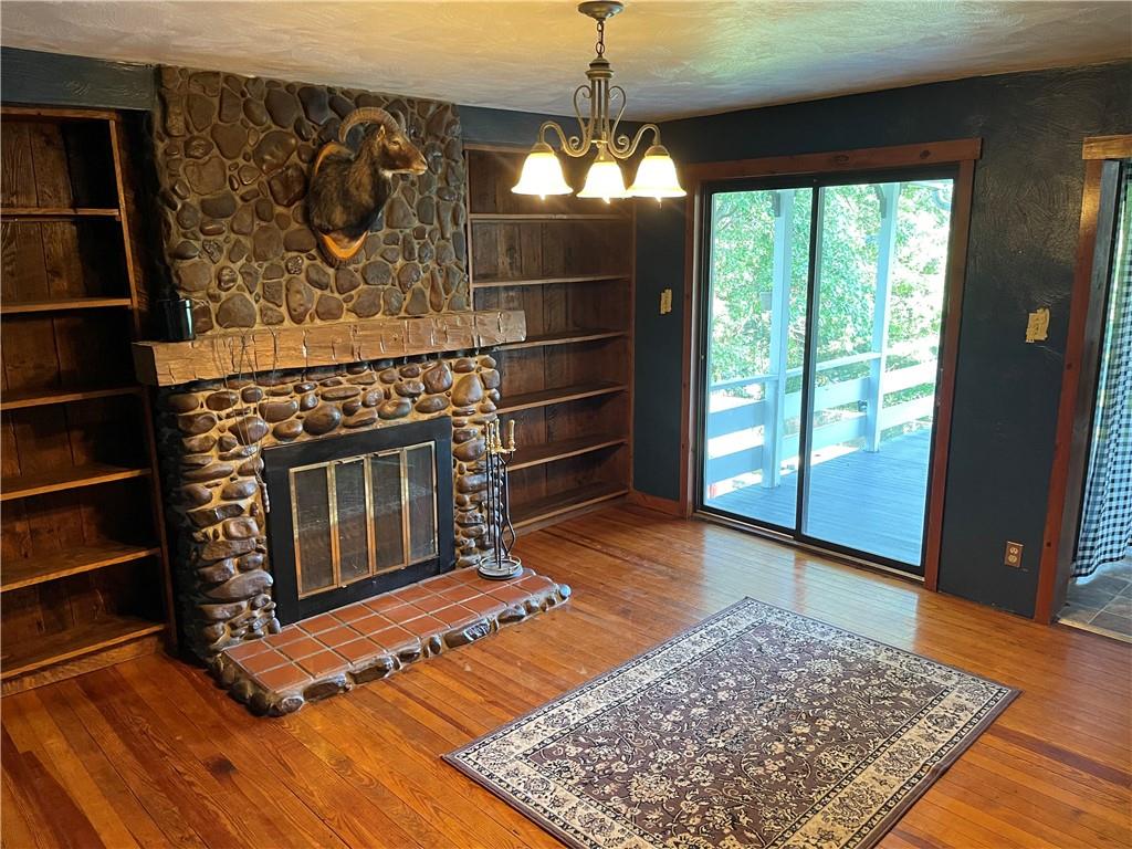 223 Lenkey Road Vanderbilt, PA 15486 - Photo 4 of 18 a living room with a fireplace and a rug