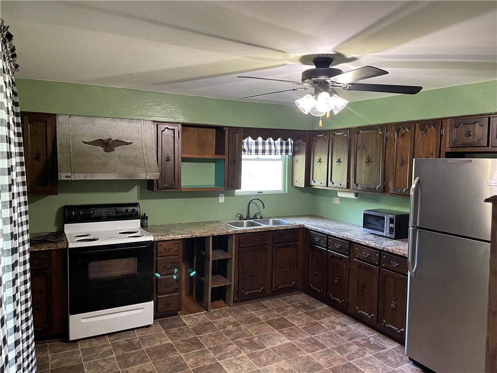 223 Lenkey Road Vanderbilt, PA 15486 - Photo 5 of 18 a kitchen with a stove sink and refrigerator