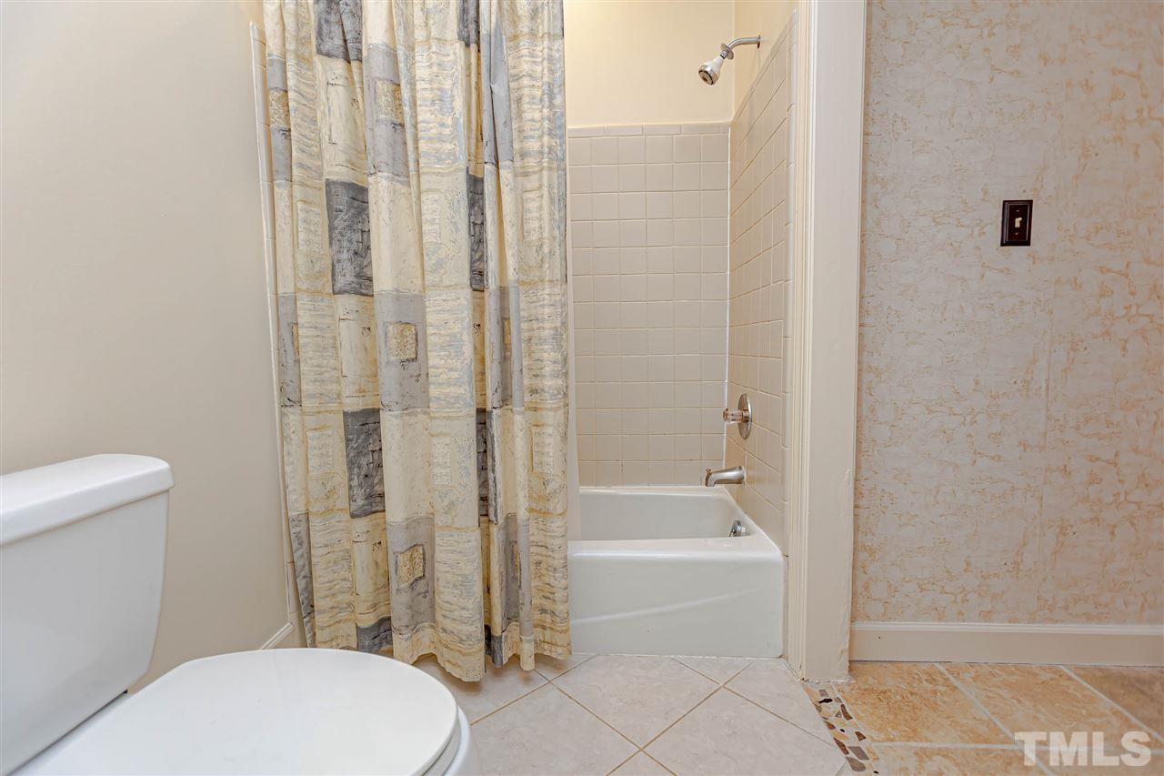 767 Weathergreen Drive Raleigh, NC 27615 - Photo 11 of 21 a bathroom with a toilet and shower