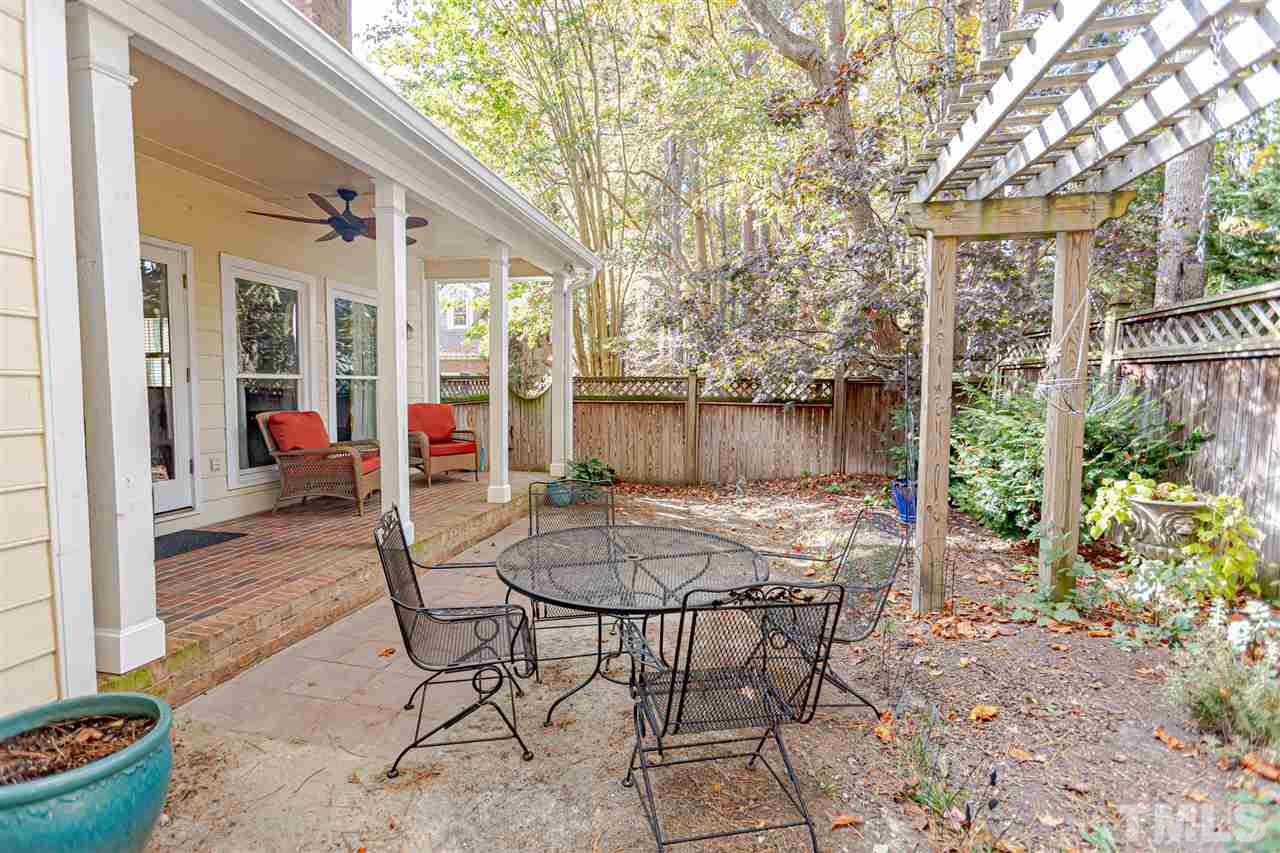 767 Weathergreen Drive Raleigh, NC 27615 - Photo 17 of 21 a backyard of a house with yard and outdoor seating