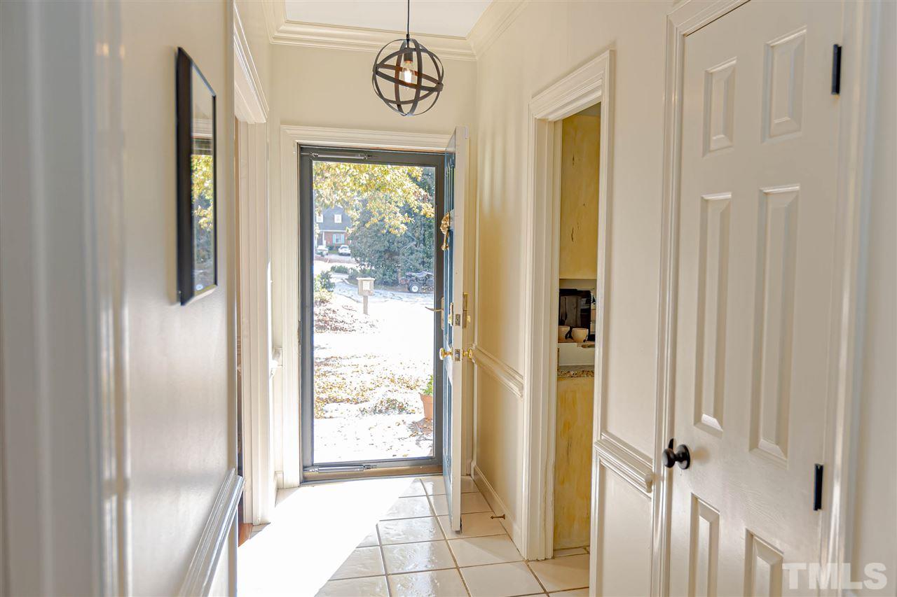 767 Weathergreen Drive Raleigh, NC 27615 - Photo 3 of 21 a view of a hallway with wooden floor and a door