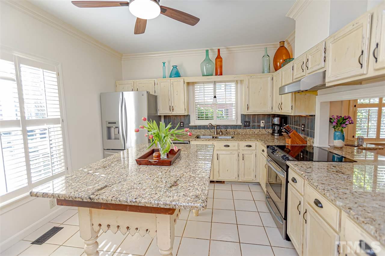 767 Weathergreen Drive Raleigh, NC 27615 - Photo 4 of 21 a kitchen with stainless steel appliances granite countertop a sink and a counter space