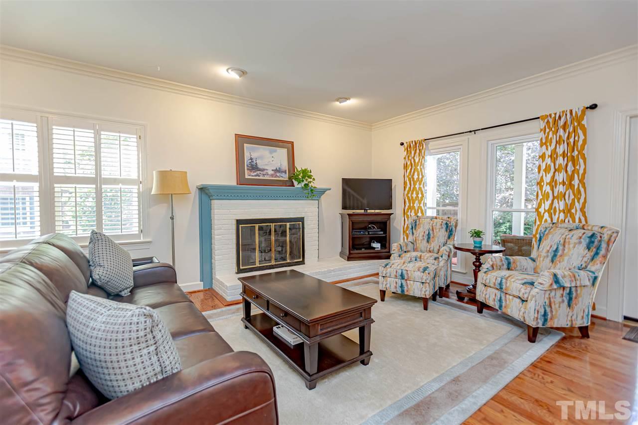 767 Weathergreen Drive Raleigh, NC 27615 - Photo 8 of 21 a living room with furniture large window and a fireplace