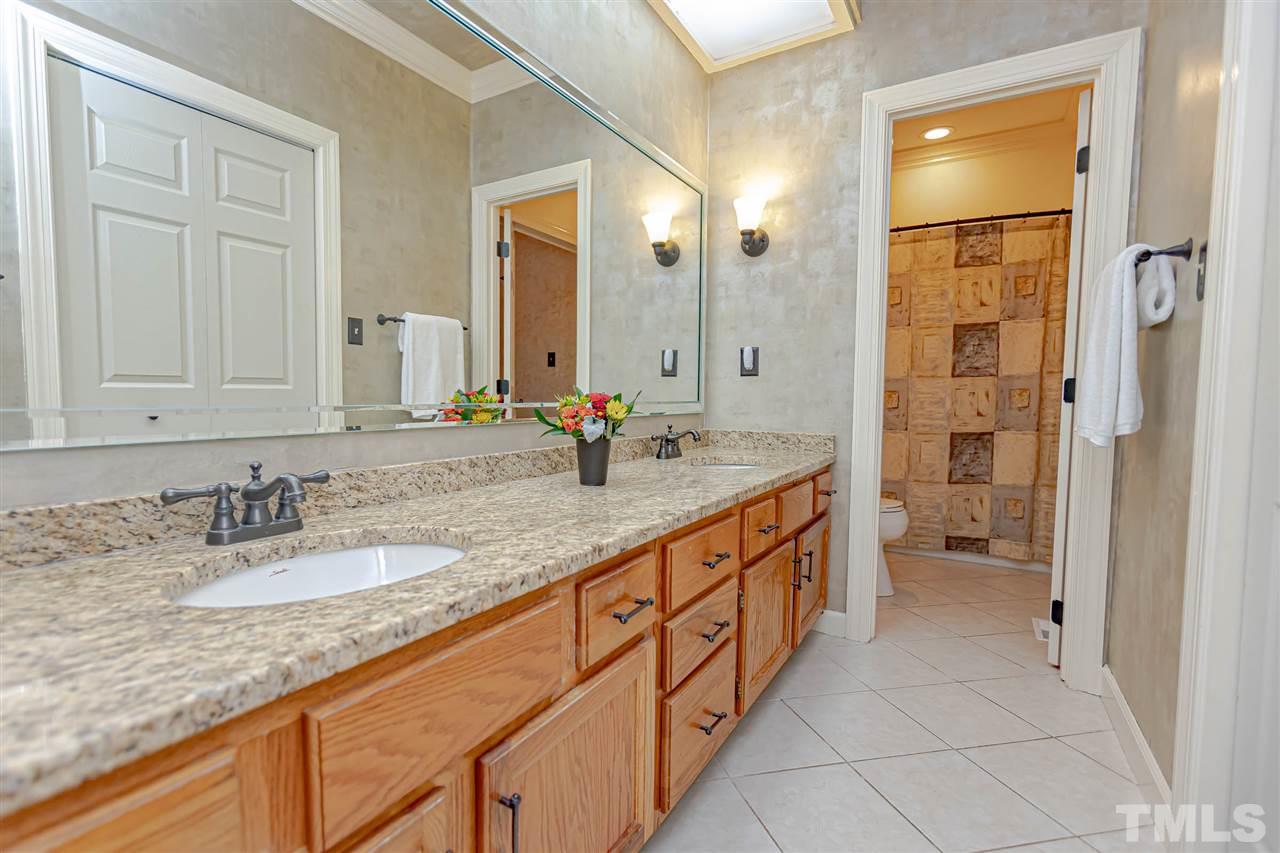 767 Weathergreen Drive Raleigh, NC 27615 - Photo 10 of 21 a bathroom with sinks double vanity and a granite counter tops