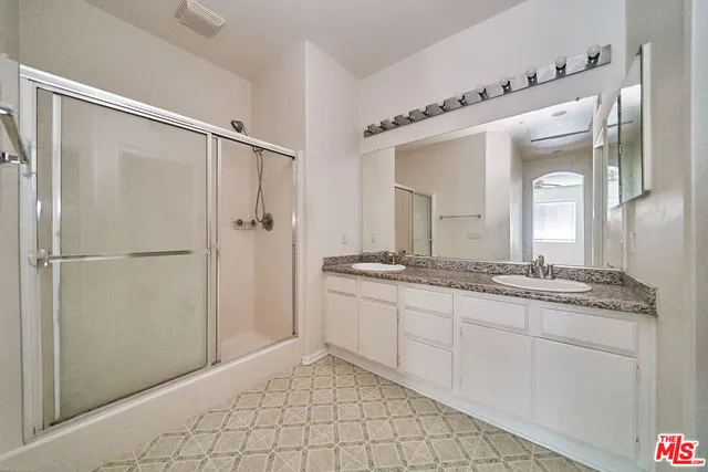 a bathroom with a granite countertop sink mirror and a toilet