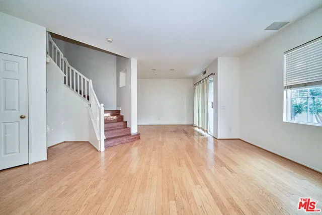 a view of a room with wooden floor and staircase