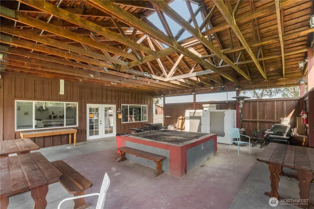 a view of a swimming pool with a patio and a yard