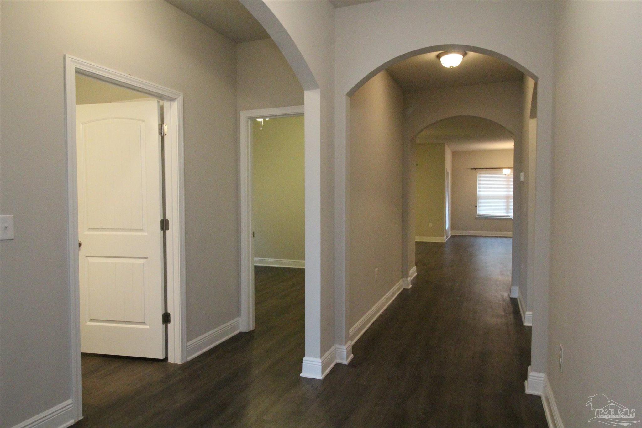 6239 Ladera Trail Pace, FL 32571 - Photo 6 of 27 a view of a hallway with wooden floor