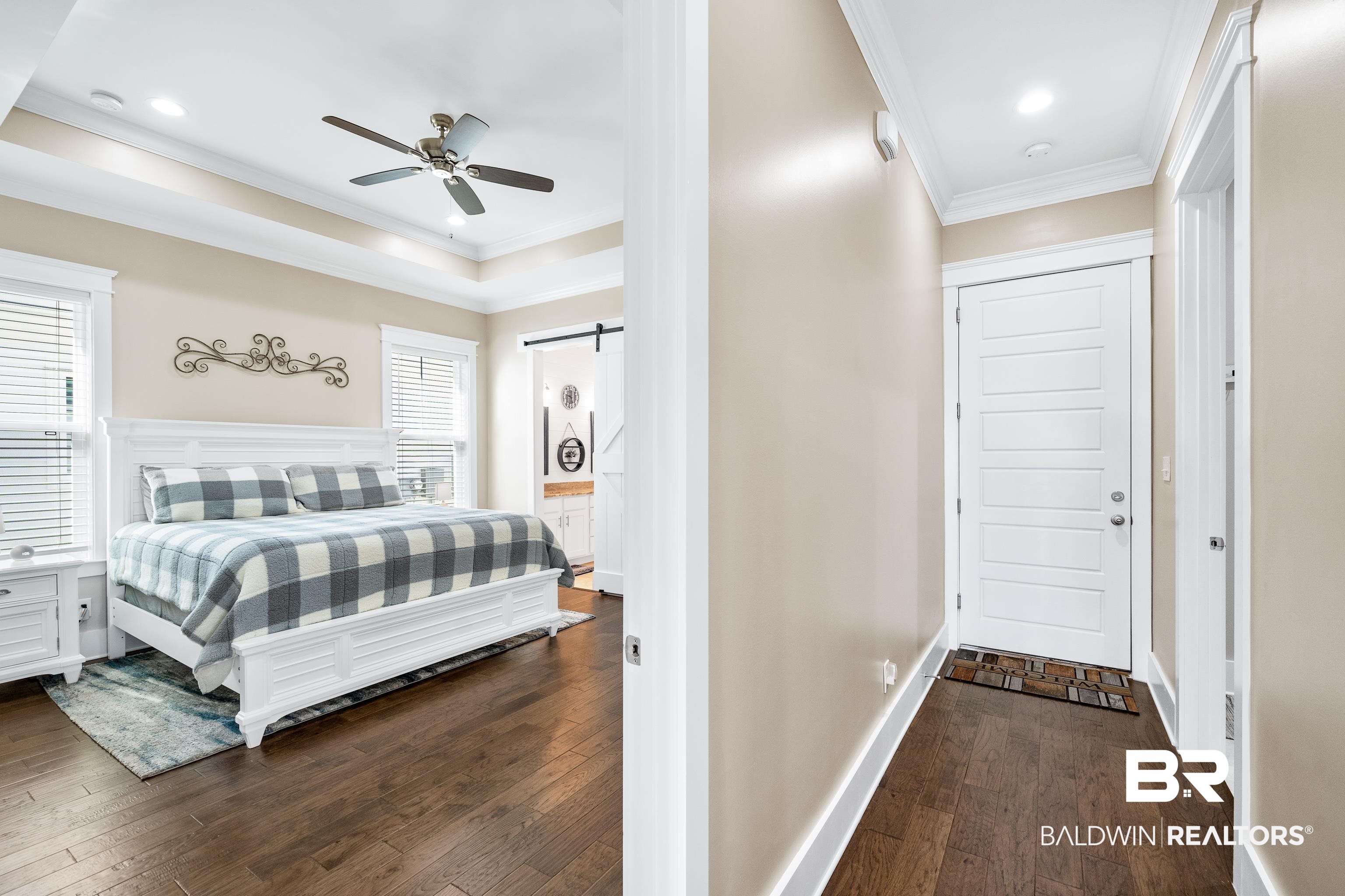 1018 Snapdragon Lane Foley, AL 36535 - Photo 20 of 37 Bedroom with a barn door, ceiling fan, wood-type flooring, and ornamental molding