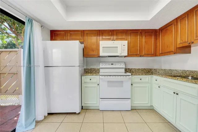 a kitchen with appliances cabinets and a sink